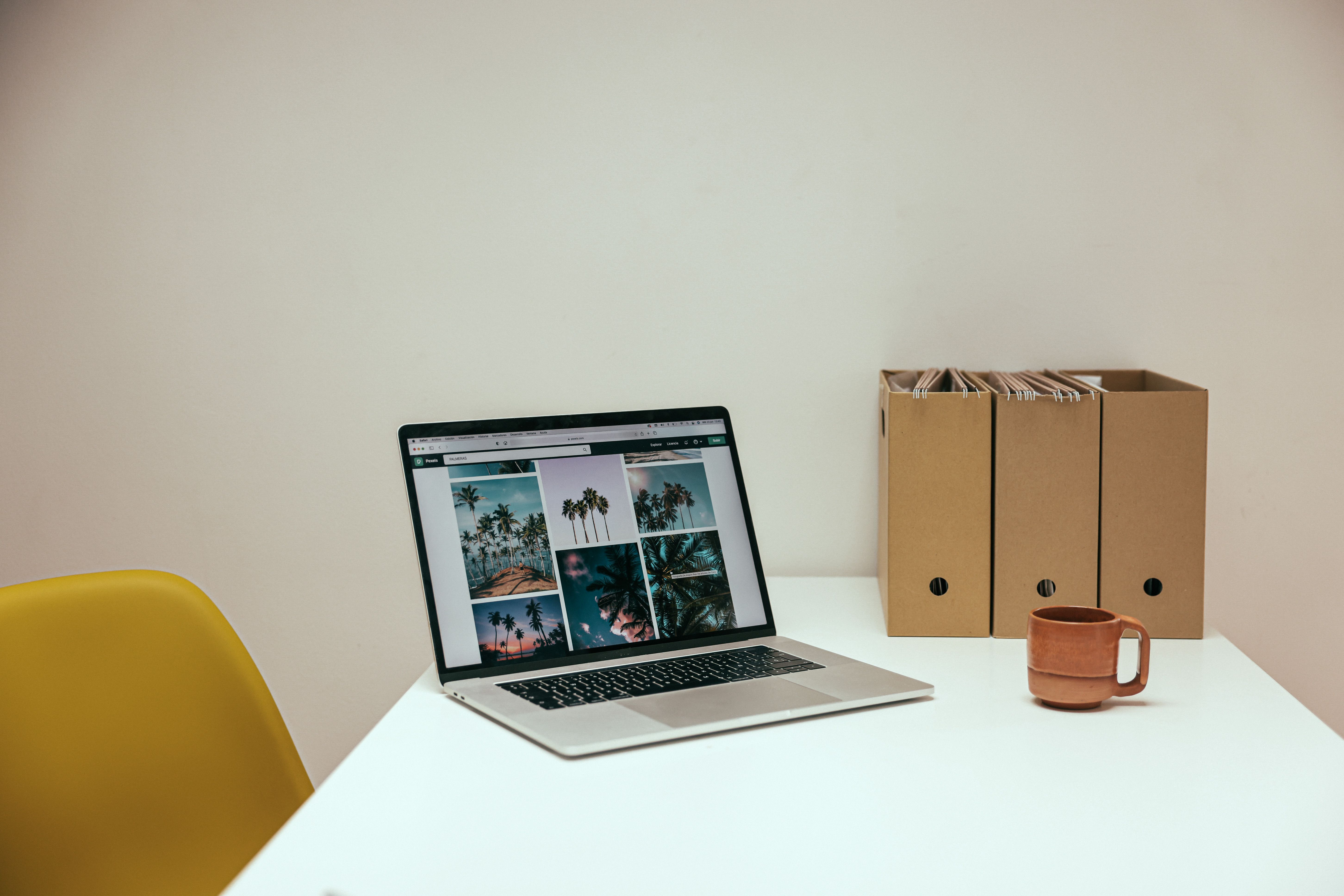 A cozy office desk setup with a laptop and coffee mug, perfect for productivity.